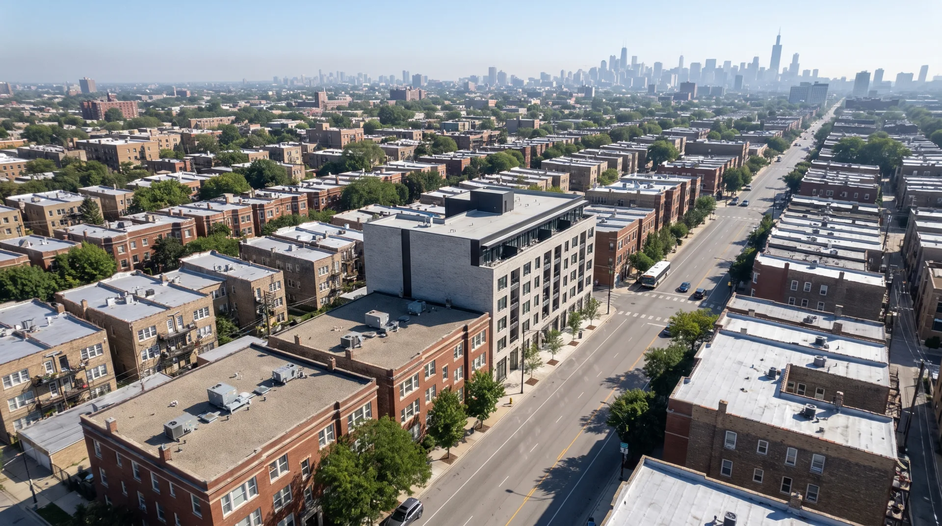 An aerial view of a Chicago grid block with alleys and two-flats, with a new seven-story gray brick building rendered into it and casting shadows that match its neighbors.