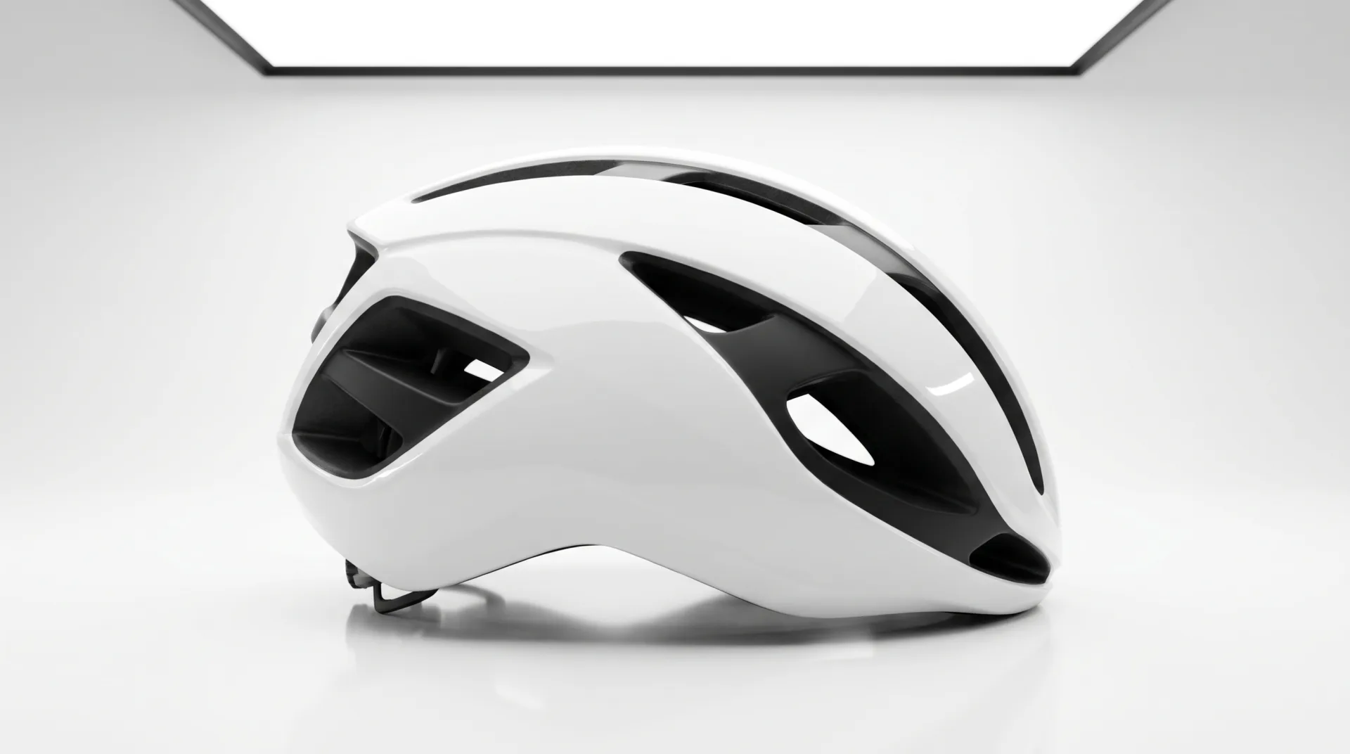 A white road cycling helmet with black vents in side profile on a white background with a soft reflection.