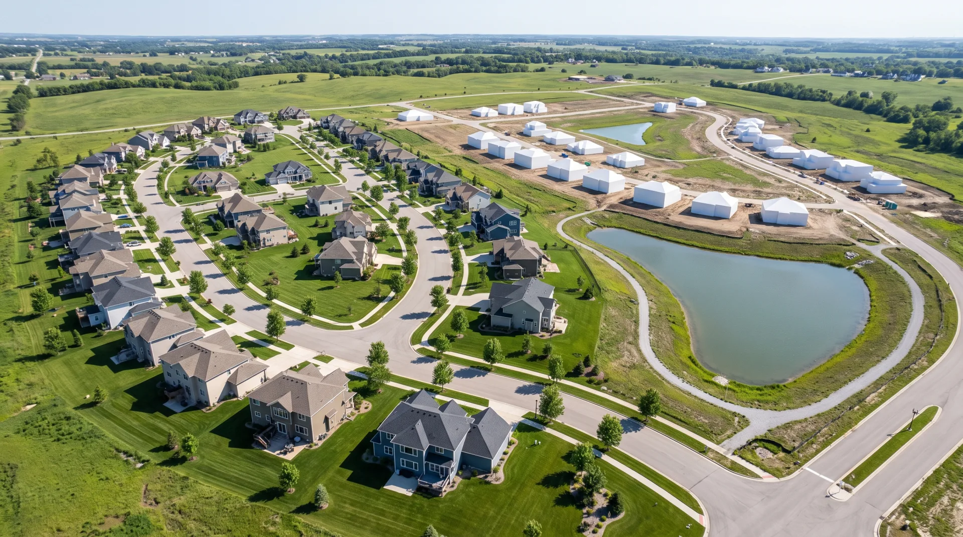 Concept work: a subdivision from high above, with the first phase of homes in full color and the second phase shown as white blocks on graded lots.